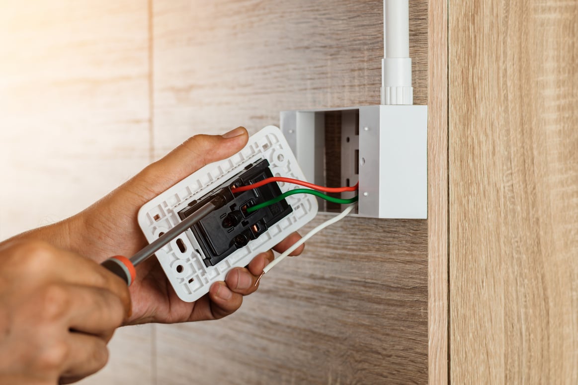 Electrician Installing a Power Outlet