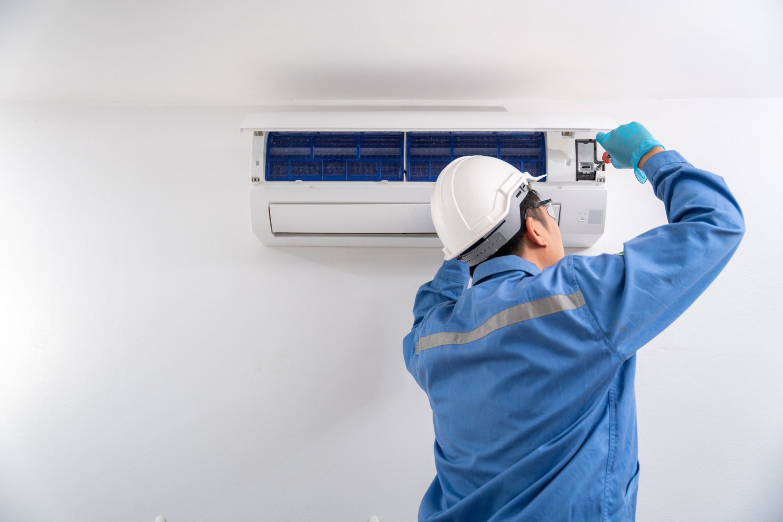 Air Conditioning Technician Repairing Air Conditioner and instal